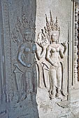 Angkor Wat temple, second enclosure, devatas sculpted in bas-relief with an extraordinary variety of intricate hair styles and costumes.